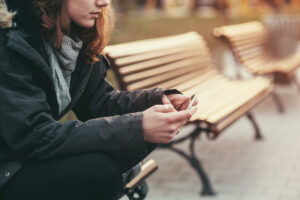 teen sad sitting on bench