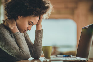 woman looking stressed at work