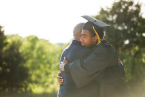 father son hugging after graduation
