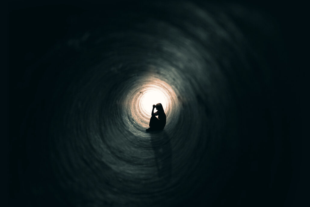 woman sitting in tunnel