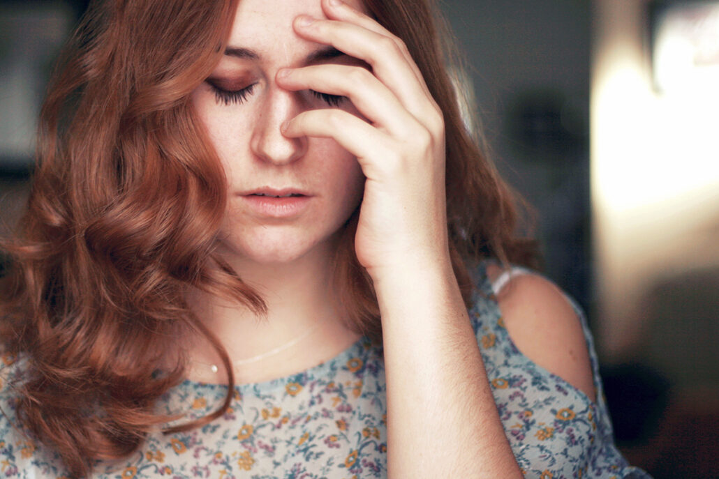 portrait of girl with her hand over one eye