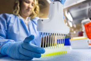 woman laboratory technician working with sample array in Genomind lab