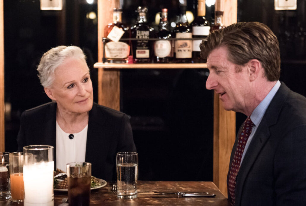 Glenn Close and Patrick Kennedy sitting at table having a discussion