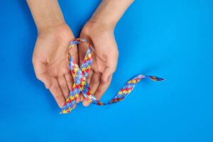 autism awareness ribbon in palm of hands