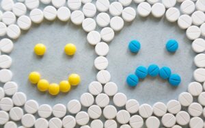 assorted pills forming two smiley faces
