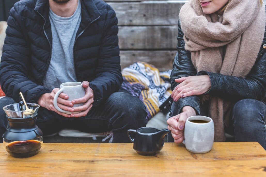 man and woman drinking coffee together