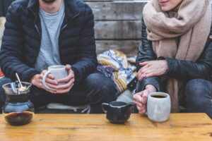man and woman drinking coffee together