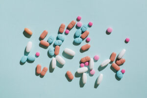 multi-color pills scattered on blue surface